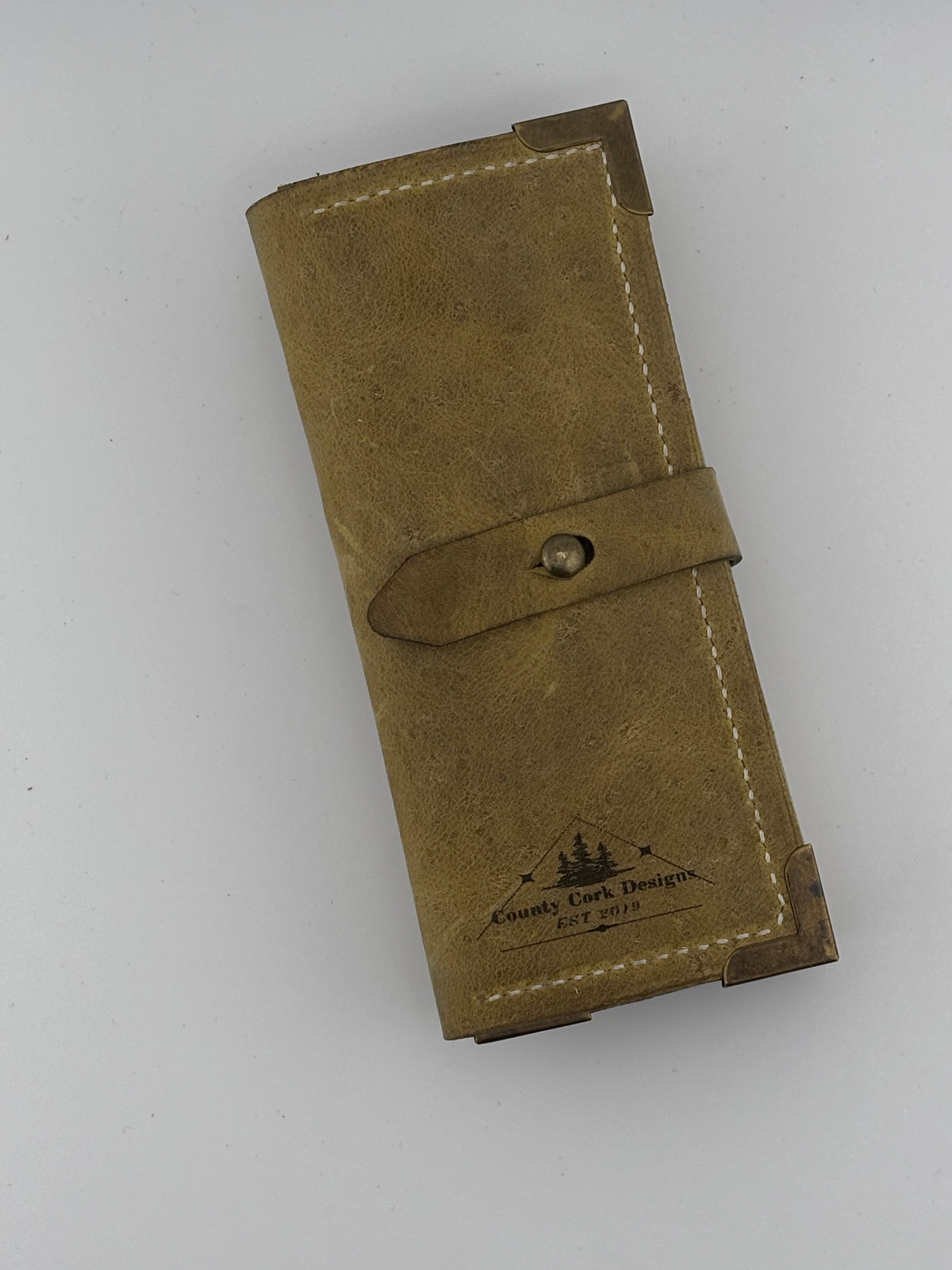 Brown leather dart wallet with a visible brand logo on a white background